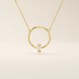 14k solid gold round necklace with a unique karma-inspired shape and central baguette-cut moissanite. Symbolic and modern gold jewelry. Ideal for minimalist everyday style.