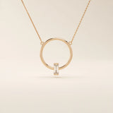 14k solid gold round necklace with a unique karma-inspired shape and central baguette-cut moissanite. Symbolic and modern gold jewelry. Ideal for minimalist everyday style.