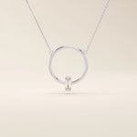 14k solid gold round necklace with a unique karma-inspired shape and central baguette-cut moissanite. Symbolic and modern gold jewelry. Ideal for minimalist everyday style.