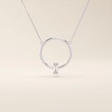 14k solid gold round necklace with a unique karma-inspired shape and central baguette-cut moissanite. Symbolic and modern gold jewelry. Ideal for minimalist everyday style.