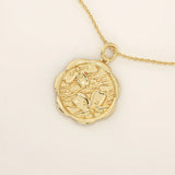 14k solid gold round pendant necklace with an embossed Sakura flower design. Delicate and nature-inspired gold jewelry. Ideal for daily minimalist style.