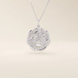 14k solid gold round pendant necklace with an embossed Sakura flower design. Delicate and nature-inspired gold jewelry. Ideal for daily minimalist style.