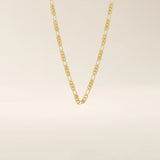 14k solid gold slim Figaro chain necklace with alternating short and long links. A classic and lightweight gold chain. Perfect for layering or daily wear.