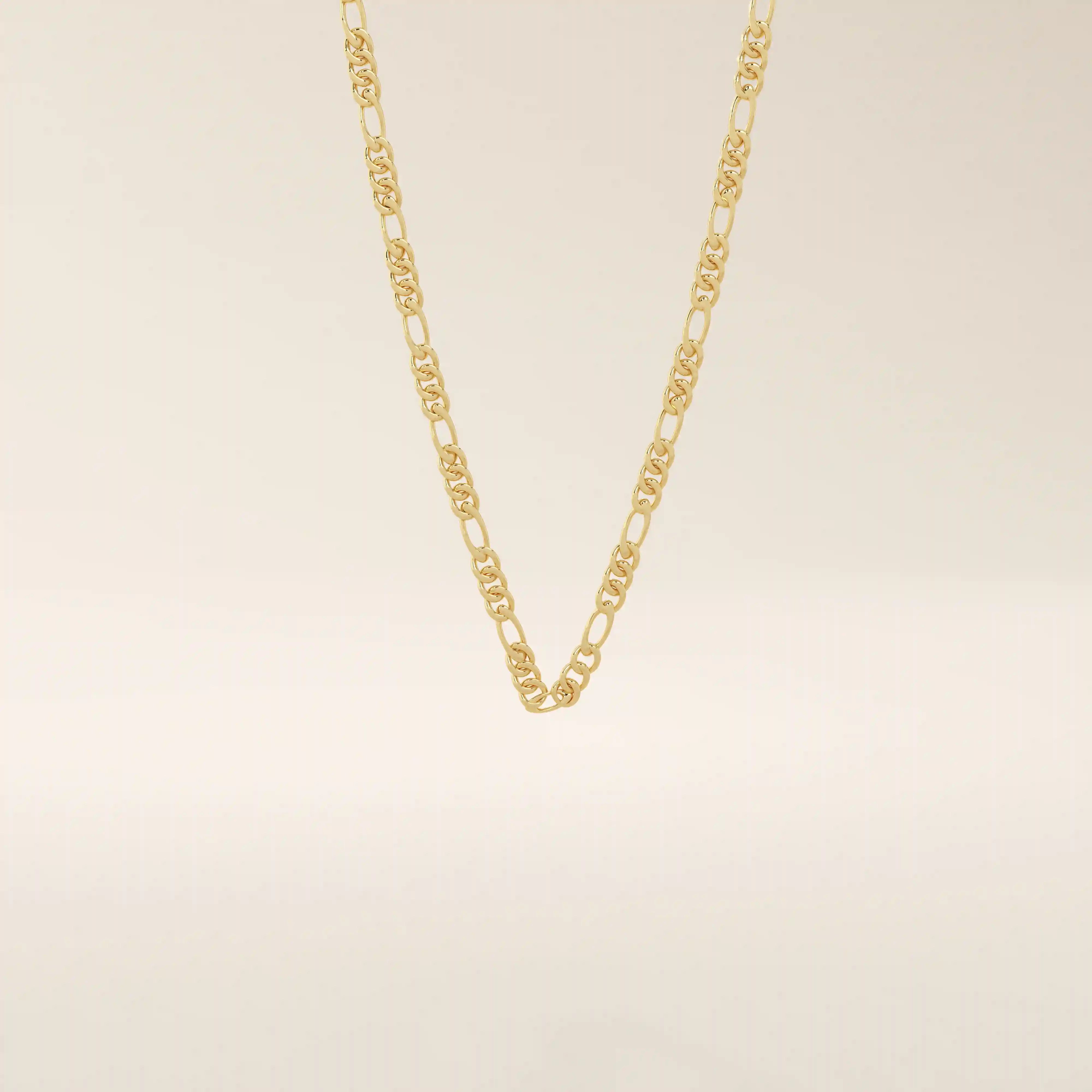 14k solid gold slim Figaro chain necklace with alternating short and long links. A classic and lightweight gold chain. Perfect for layering or daily wear.