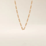 14k solid gold slim Figaro chain necklace with alternating short and long links. A classic and lightweight gold chain. Perfect for layering or daily wear.