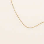 14k solid gold slim link chain necklace with a lightweight and polished finish. A delicate and timeless gold chain. Ideal for layering or wearing solo.