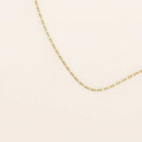 14k solid gold slim link chain necklace with a lightweight and polished finish. A delicate and timeless gold chain. Ideal for layering or wearing solo.