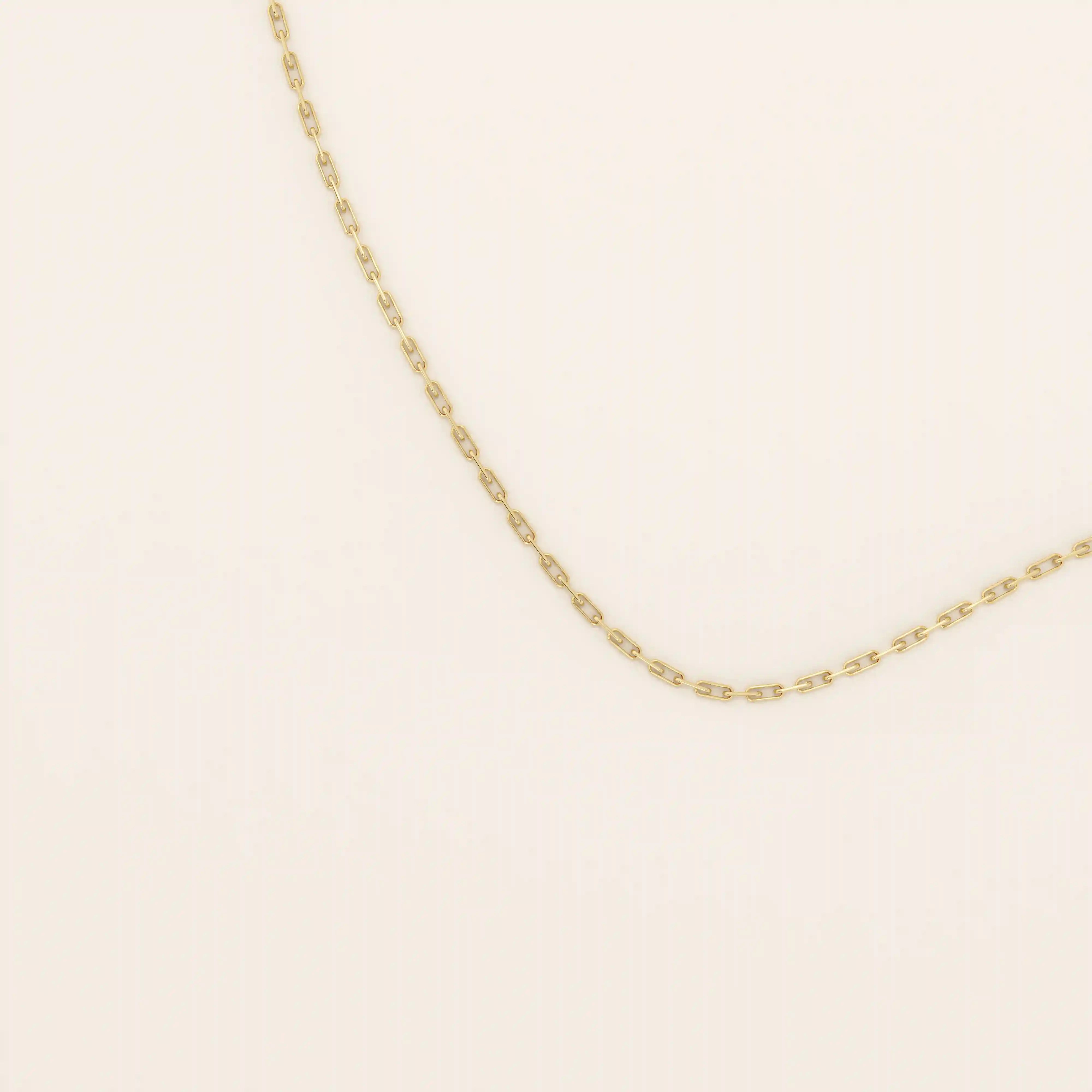 14k solid gold slim link chain necklace with a lightweight and polished finish. A delicate and timeless gold chain. Ideal for layering or wearing solo.