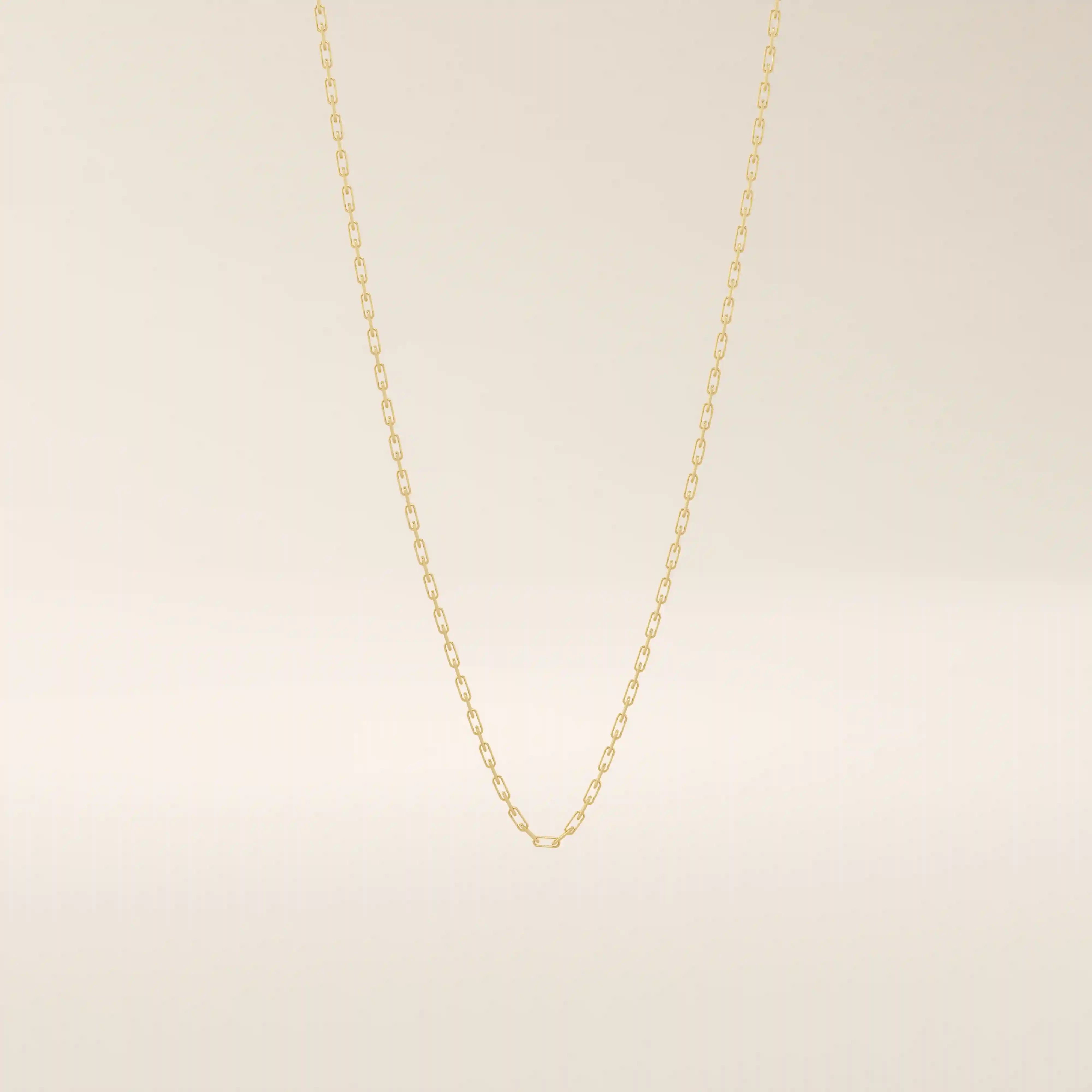 14k solid gold slim link chain necklace with a lightweight and polished finish. A delicate and timeless gold chain. Ideal for layering or wearing solo.