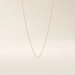 14k solid gold slim link chain necklace with a lightweight and polished finish. A delicate and timeless gold chain. Ideal for layering or wearing solo.