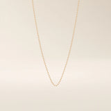 14k solid gold slim link chain necklace with a lightweight and polished finish. A delicate and timeless gold chain. Ideal for layering or wearing solo.