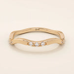 14k solid gold slim stacking ring with a delicate curvy band design and tiny moissanite accents. Minimalist and elegant for everyday wear.