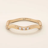 14k solid gold slim stacking ring with a delicate curvy band design and tiny moissanite accents. Minimalist and elegant for everyday wear.