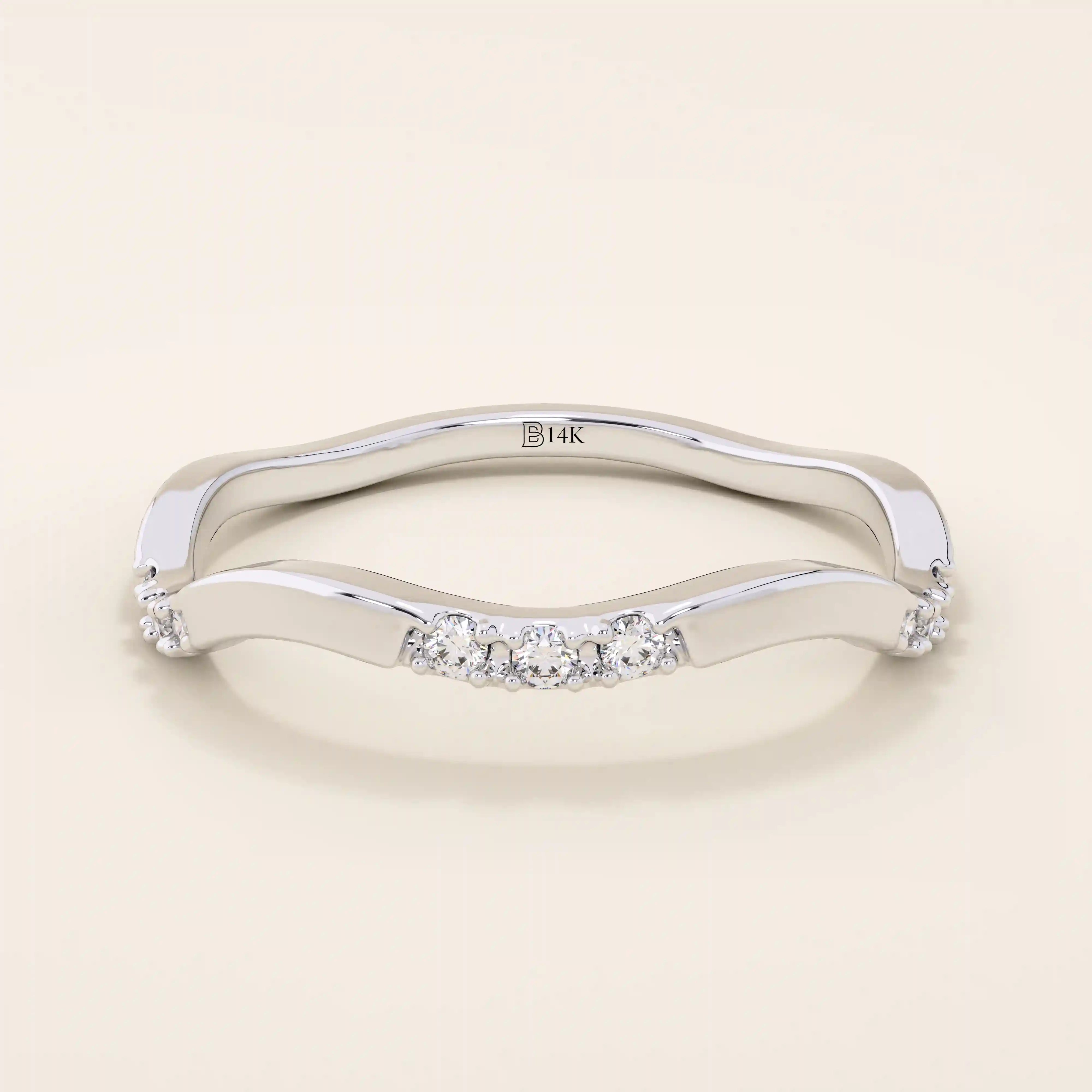 14k solid gold slim stacking ring with a delicate curvy band design and tiny moissanite accents. Minimalist and elegant for everyday wear.