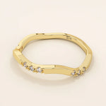 14k solid gold slim stacking ring with a delicate curvy band design and tiny moissanite accents. Minimalist and elegant for everyday wear.