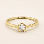 14k solid gold solitaire engagement or promise ring featuring a delicate small flower design. Minimalist and feminine everyday jewelry.
