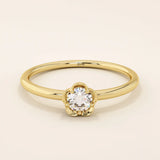 14k solid gold solitaire engagement or promise ring featuring a delicate small flower design. Minimalist and feminine everyday jewelry.