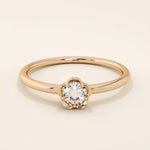 14k solid gold solitaire engagement or promise ring featuring a delicate small flower design. Minimalist and feminine everyday jewelry.