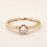 14k solid gold solitaire engagement or promise ring featuring a delicate small flower design. Minimalist and feminine everyday jewelry.