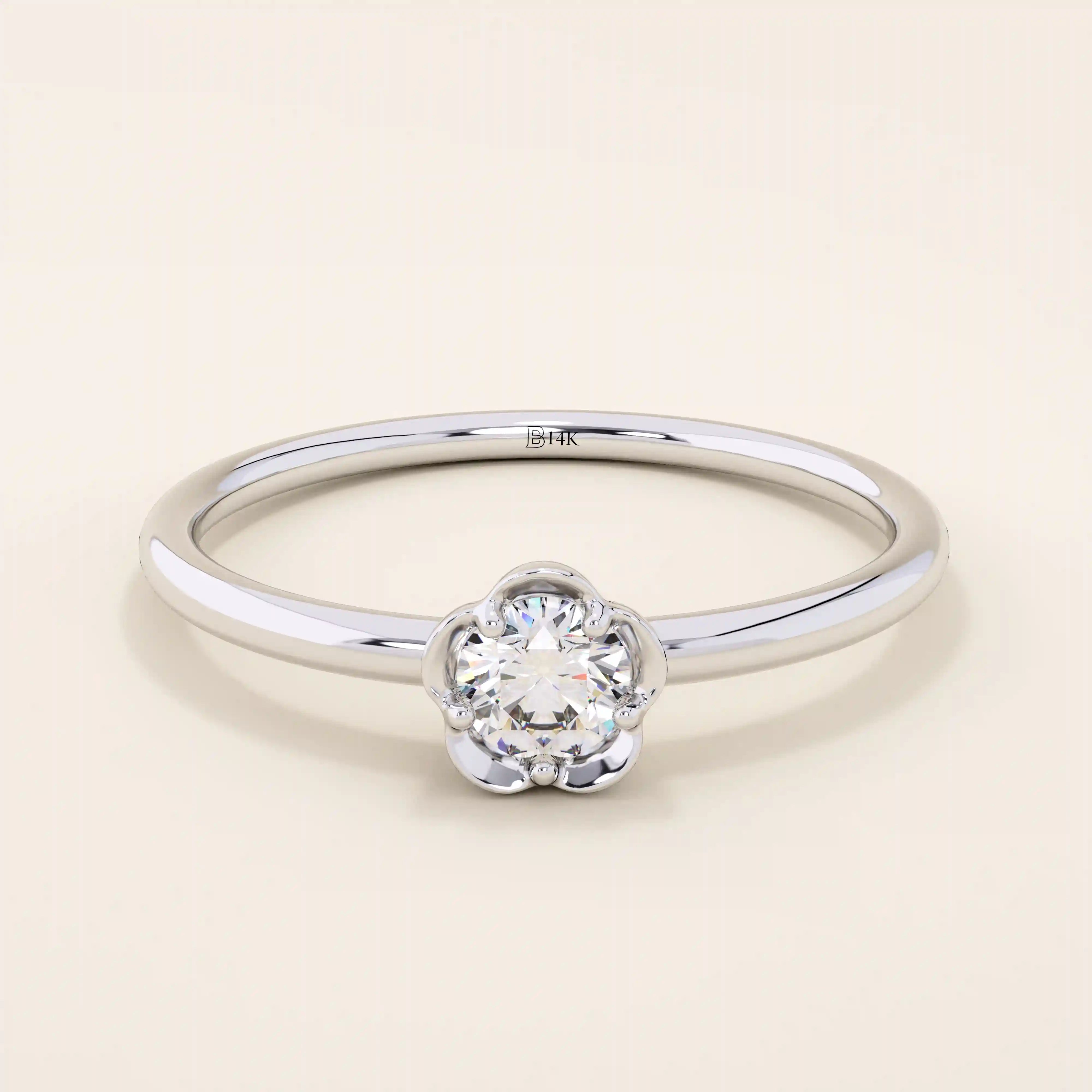 14k solid gold solitaire engagement or promise ring featuring a delicate small flower design. Minimalist and feminine everyday jewelry.