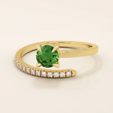 14k solid gold spiral wrap ring featuring a vivid green emerald gemstone. A bold yet elegant design with fluid curves. Perfect as a statement ring or unique gift.