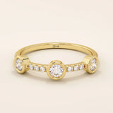 14k solid gold stacking ring featuring a half-eternity design with three bezel-set moissanites. Minimalist and versatile style.