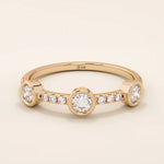 14k solid gold stacking ring featuring a half-eternity design with three bezel-set moissanites. Minimalist and versatile style.