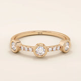 14k solid gold stacking ring featuring a half-eternity design with three bezel-set moissanites. Minimalist and versatile style.