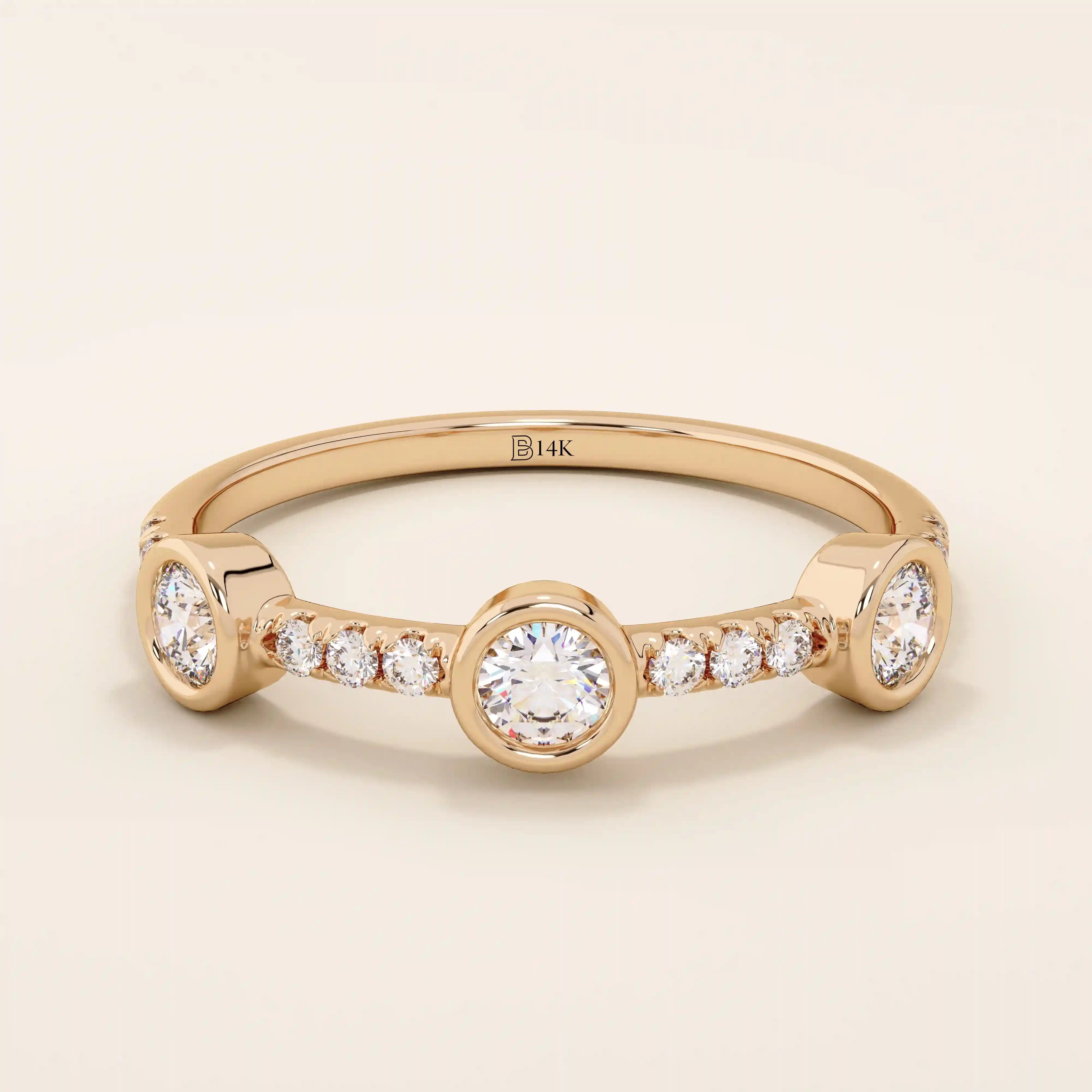 14k solid gold stacking ring featuring a half-eternity design with three bezel-set moissanites. Minimalist and versatile style.