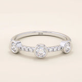 14k solid gold stacking ring featuring a half-eternity design with three bezel-set moissanites. Minimalist and versatile style.