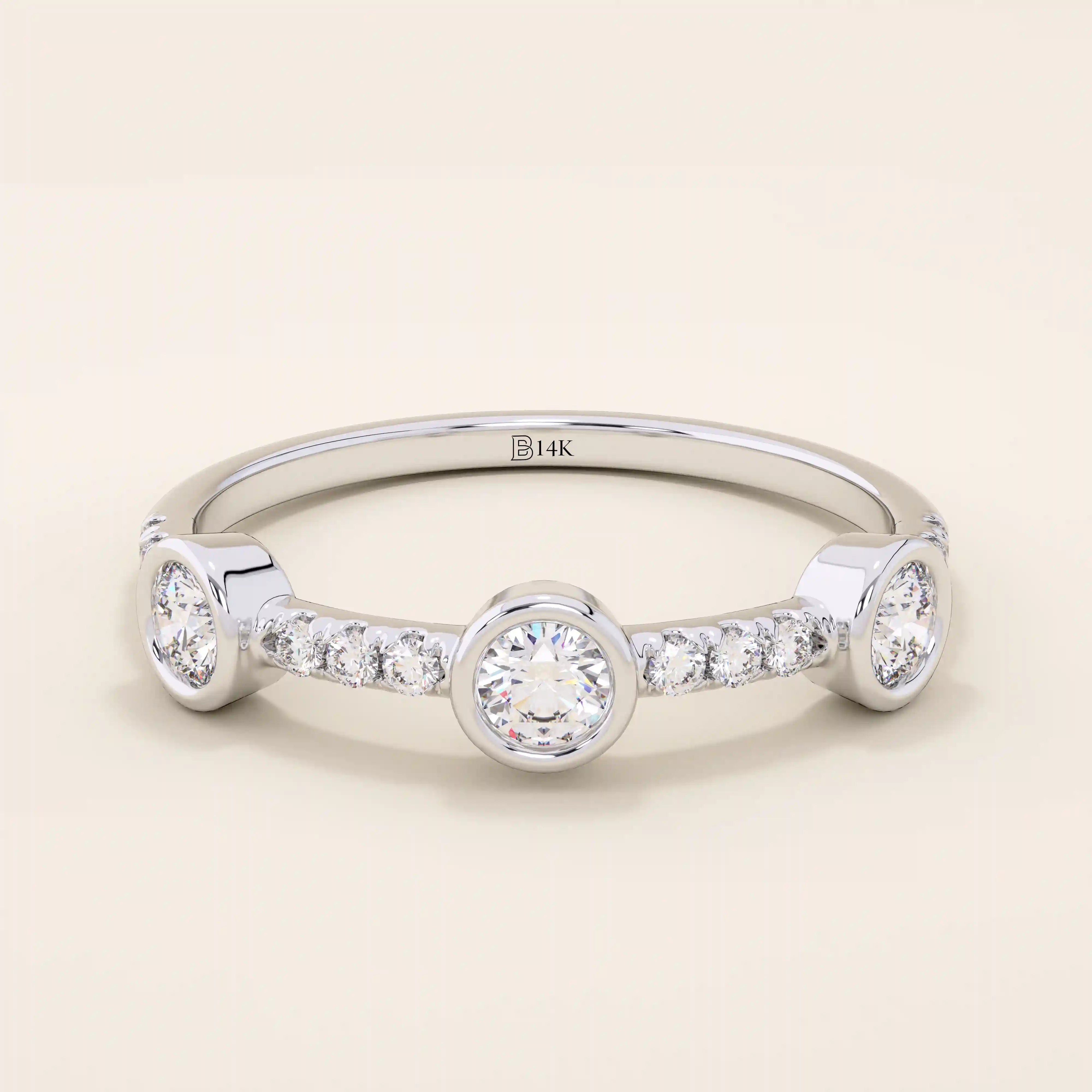 14k solid gold stacking ring featuring a half-eternity design with three bezel-set moissanites. Minimalist and versatile style.