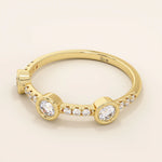 14k solid gold stacking ring featuring a half-eternity design with three bezel-set moissanites. Minimalist and versatile style.