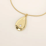14k solid gold teardrop pendant necklace featuring a single tiny moissanite in the center. Minimalist and timeless jewelry design. Perfect for everyday wear.