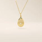 14k solid gold teardrop pendant necklace featuring a single tiny moissanite in the center. Minimalist and timeless jewelry design. Perfect for everyday wear.
