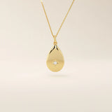14k solid gold teardrop pendant necklace featuring a single tiny moissanite in the center. Minimalist and timeless jewelry design. Perfect for everyday wear.