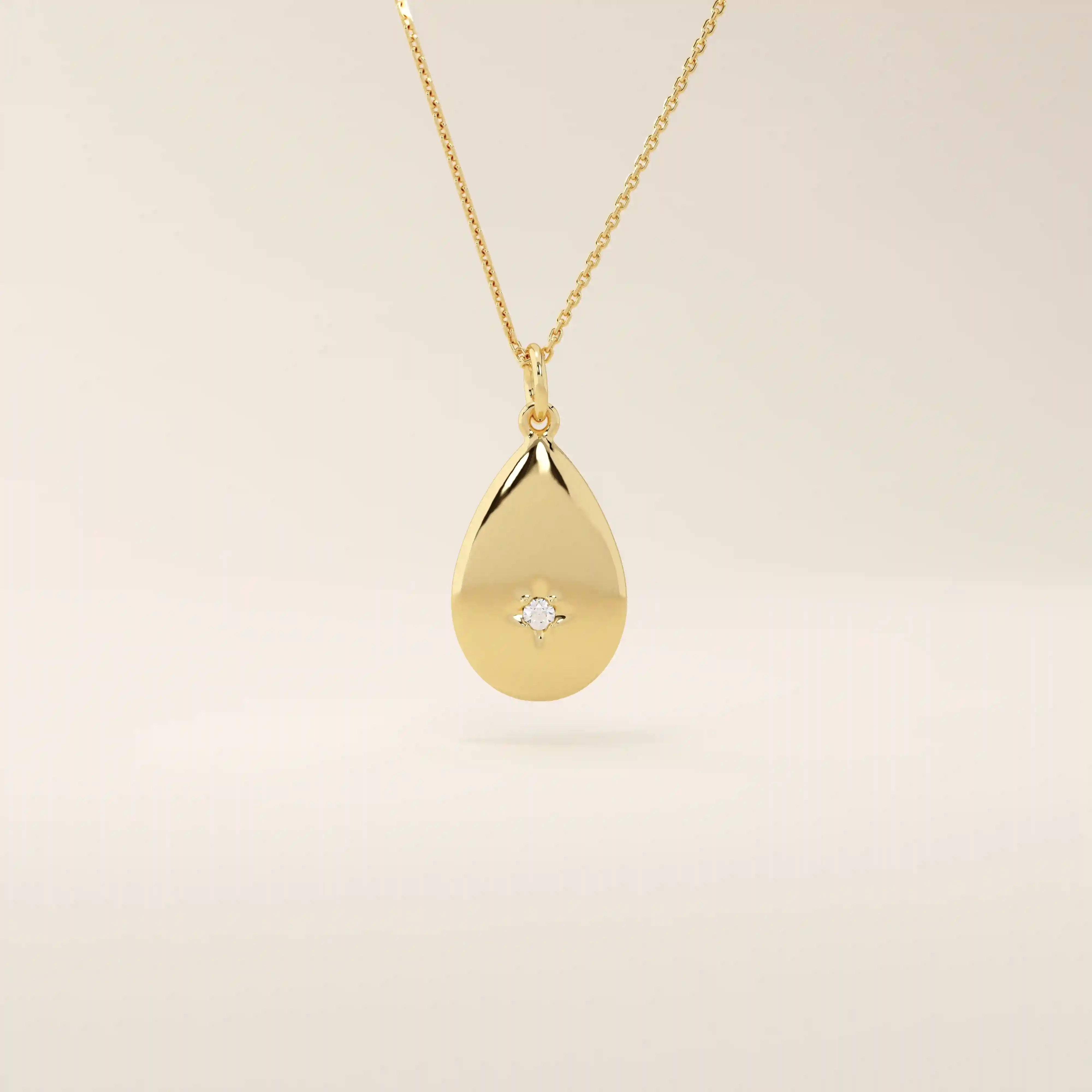 14k solid gold teardrop pendant necklace featuring a single tiny moissanite in the center. Minimalist and timeless jewelry design. Perfect for everyday wear.