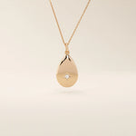 14k solid gold teardrop pendant necklace featuring a single tiny moissanite in the center. Minimalist and timeless jewelry design. Perfect for everyday wear.