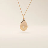 14k solid gold teardrop pendant necklace featuring a single tiny moissanite in the center. Minimalist and timeless jewelry design. Perfect for everyday wear.