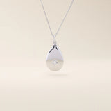 14k solid gold teardrop pendant necklace featuring a single tiny moissanite in the center. Minimalist and timeless jewelry design. Perfect for everyday wear.