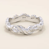 Refined 14k solid white gold ivy leaf wedding band with intricate leaf patterns encircling the ring in a continuous, textured design. The high-polish finish contrasts beautifully with the carved details, creating a timeless botanical-inspired wedding or anniversary band.
