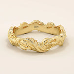 Elegant 14k solid yellow gold wedding band featuring bold, raised ivy leaf motifs wrapping seamlessly around the band. The intricate nature-inspired design showcases polished contours and subtle curves, adding depth and dimension. Perfect as a statement piece or unique nature-themed wedding ring.
