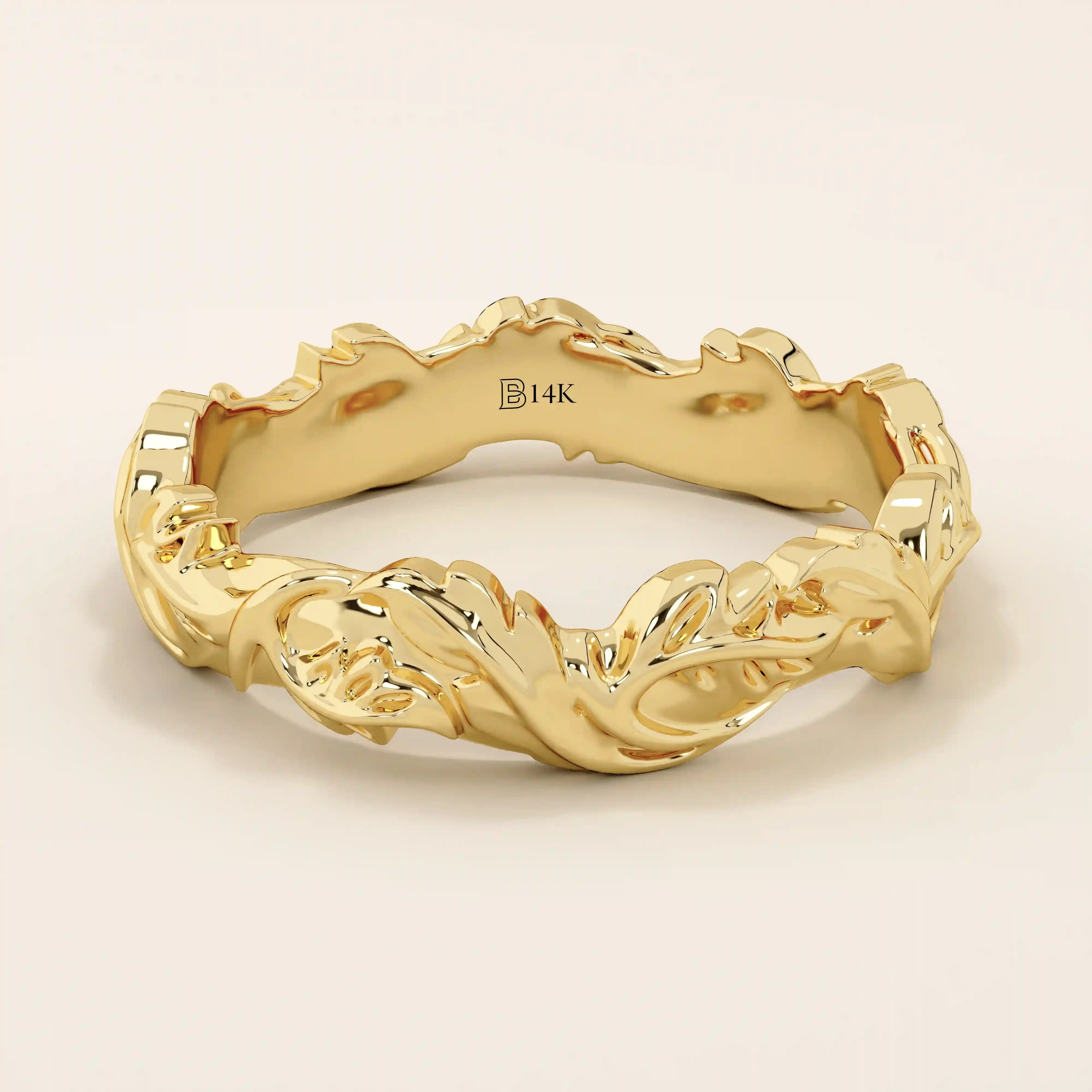 Elegant 14k solid yellow gold wedding band featuring bold, raised ivy leaf motifs wrapping seamlessly around the band. The intricate nature-inspired design showcases polished contours and subtle curves, adding depth and dimension. Perfect as a statement piece or unique nature-themed wedding ring.
