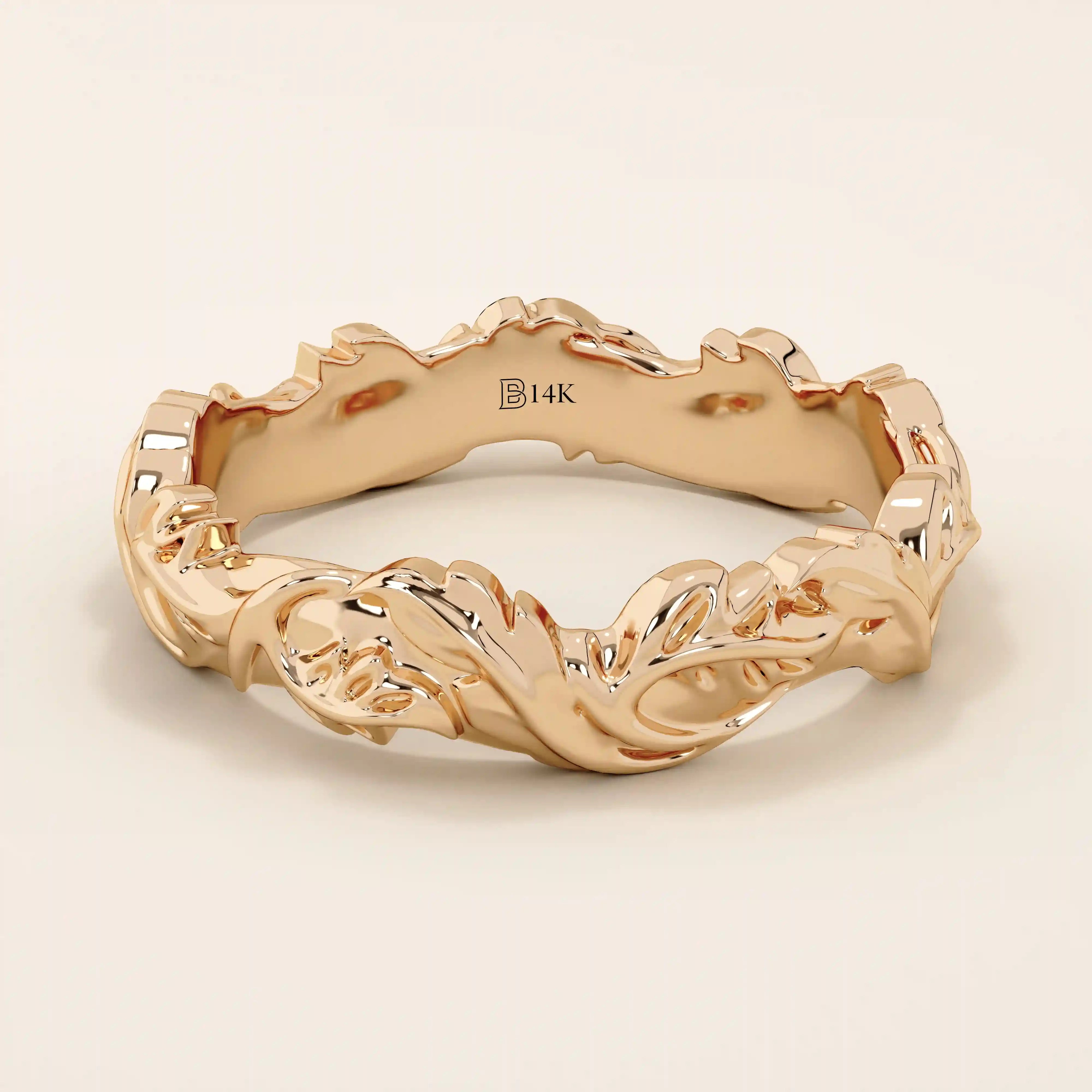 Romantic 14k solid rose gold wedding band adorned with sculpted ivy leaf motifs flowing around the entire band. The warm blush tones of the gold enhance the nature-inspired design, making it an ideal choice for those seeking a unique and meaningful botanical wedding ring.
