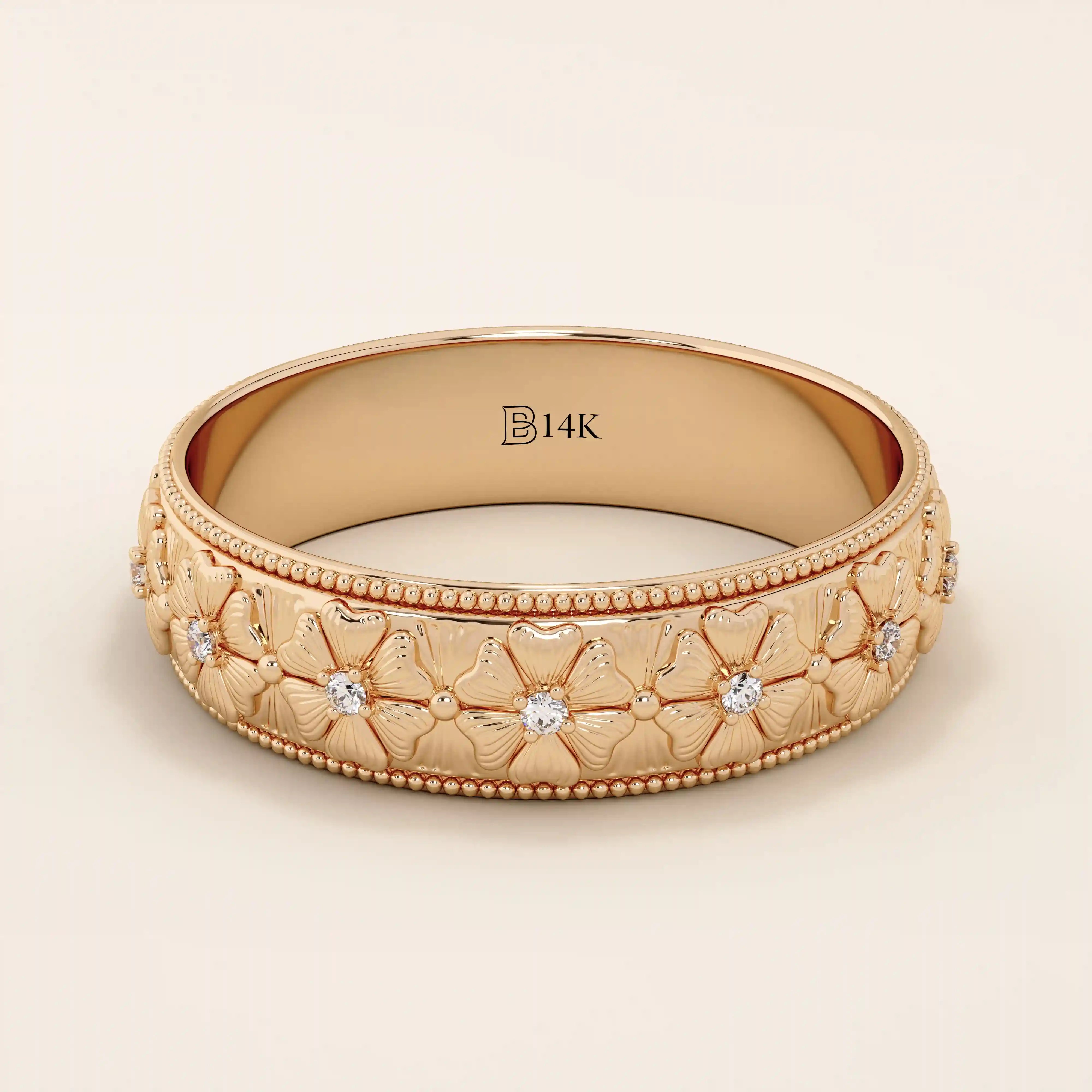 14k solid gold wedding band with embossed flower patterns wrapping around the band. A romantic and textured gold ring. Perfect for daily wear or as a unique wedding band.