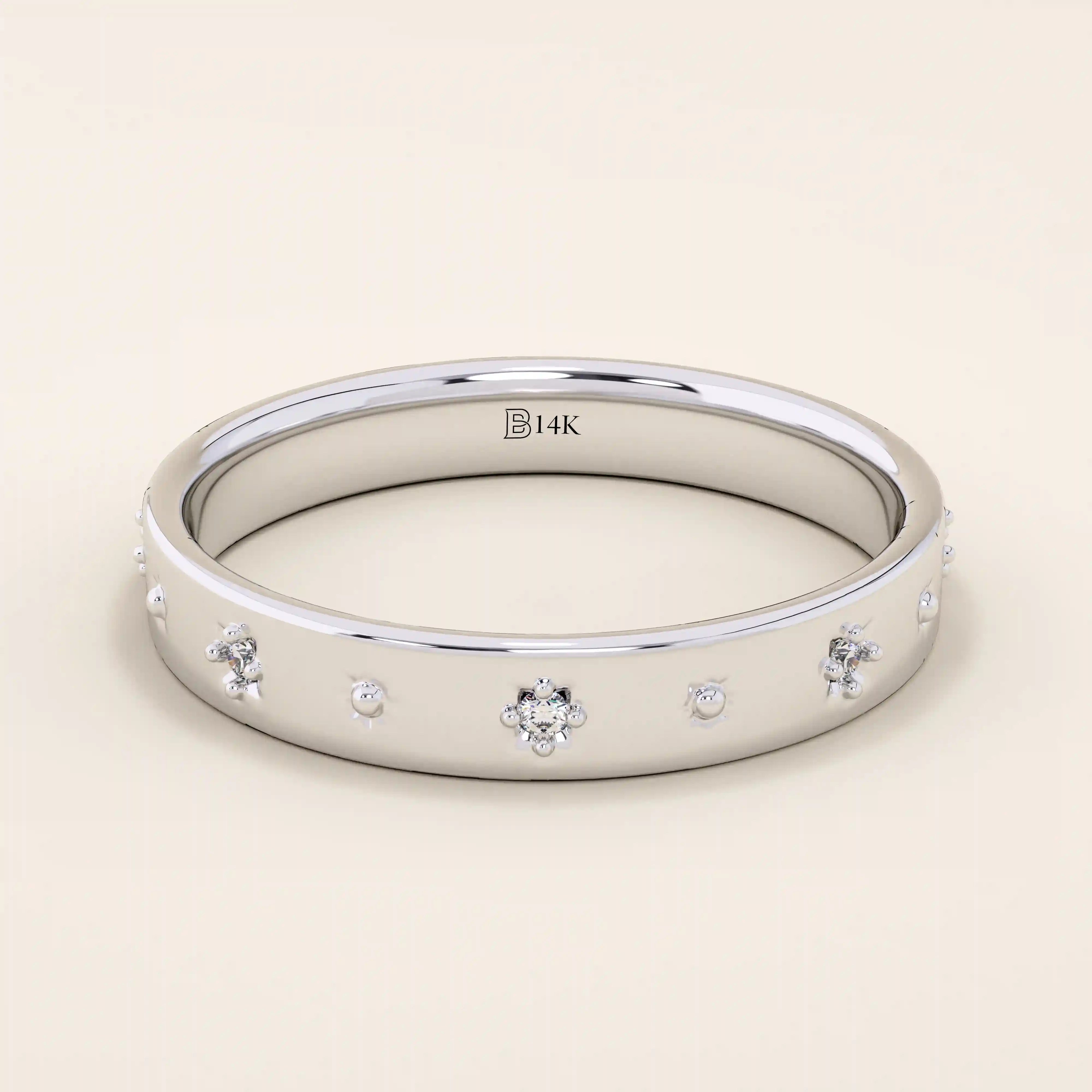 14k solid white gold wedding band featuring dainty celestial star engravings with shimmering moissanites set in their centers, offering a sleek and modern stacking ring style.

