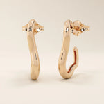 14k solid rose gold abstract curved hoop stud earrings, designed with smooth flowing lines and a reflective finish.
