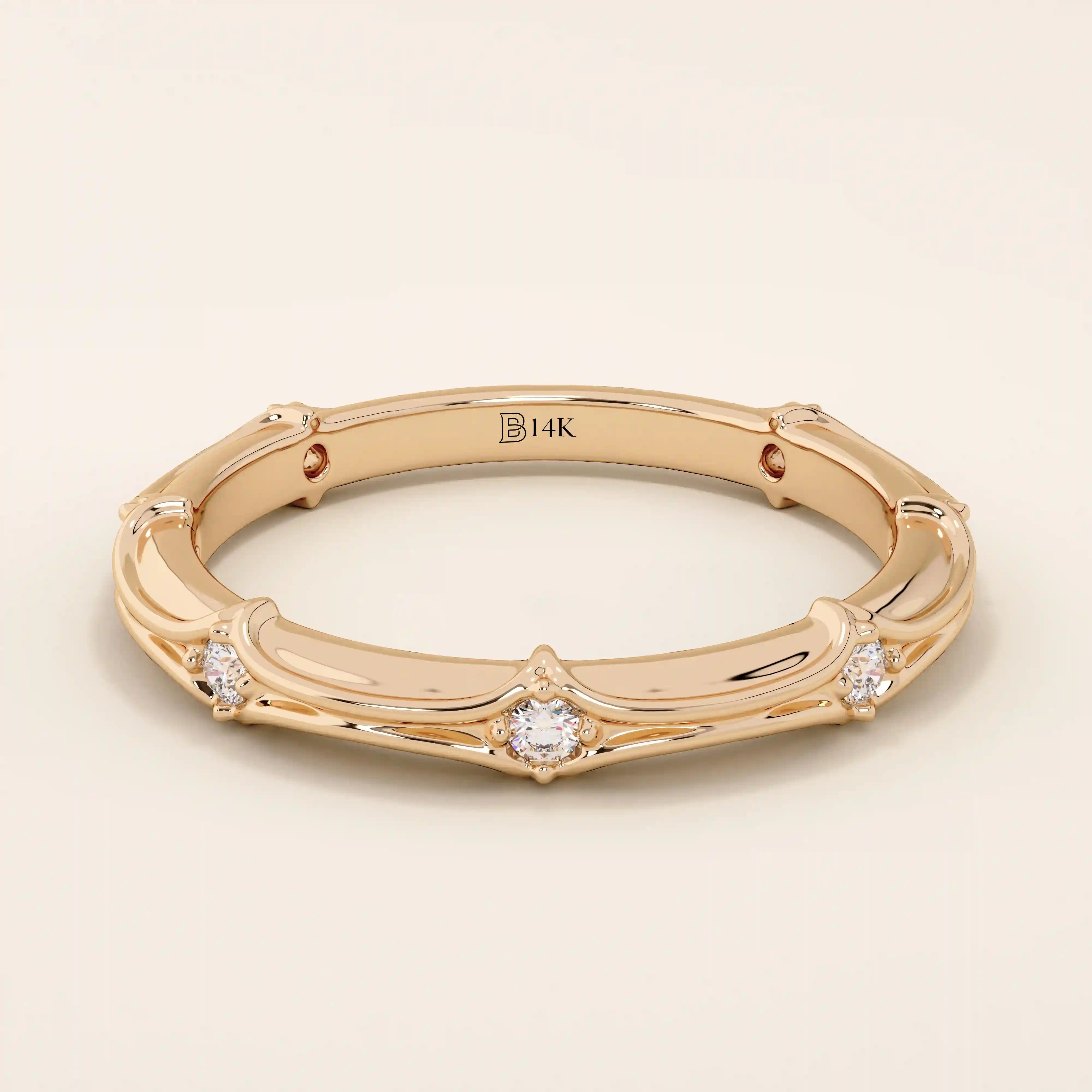 14k solid rose gold bamboo-inspired wedding band with evenly spaced round brilliant-cut moissanites
