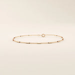 14k solid rose gold bar chain bracelet with smooth rectangular accents, blending warm rosy tones with an understated, minimalist design.
