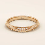 14k solid rose gold braided wedding band with a row of sparkling round diamonds, romantic and dainty design
