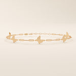 14k solid rose gold butterfly charm bracelet showcasing dainty butterfly designs joined with slim geometric chain links.

